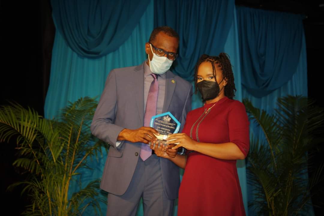 "Azendae Popo Receiving an Award From the Prime Minister of Saint Lucia."